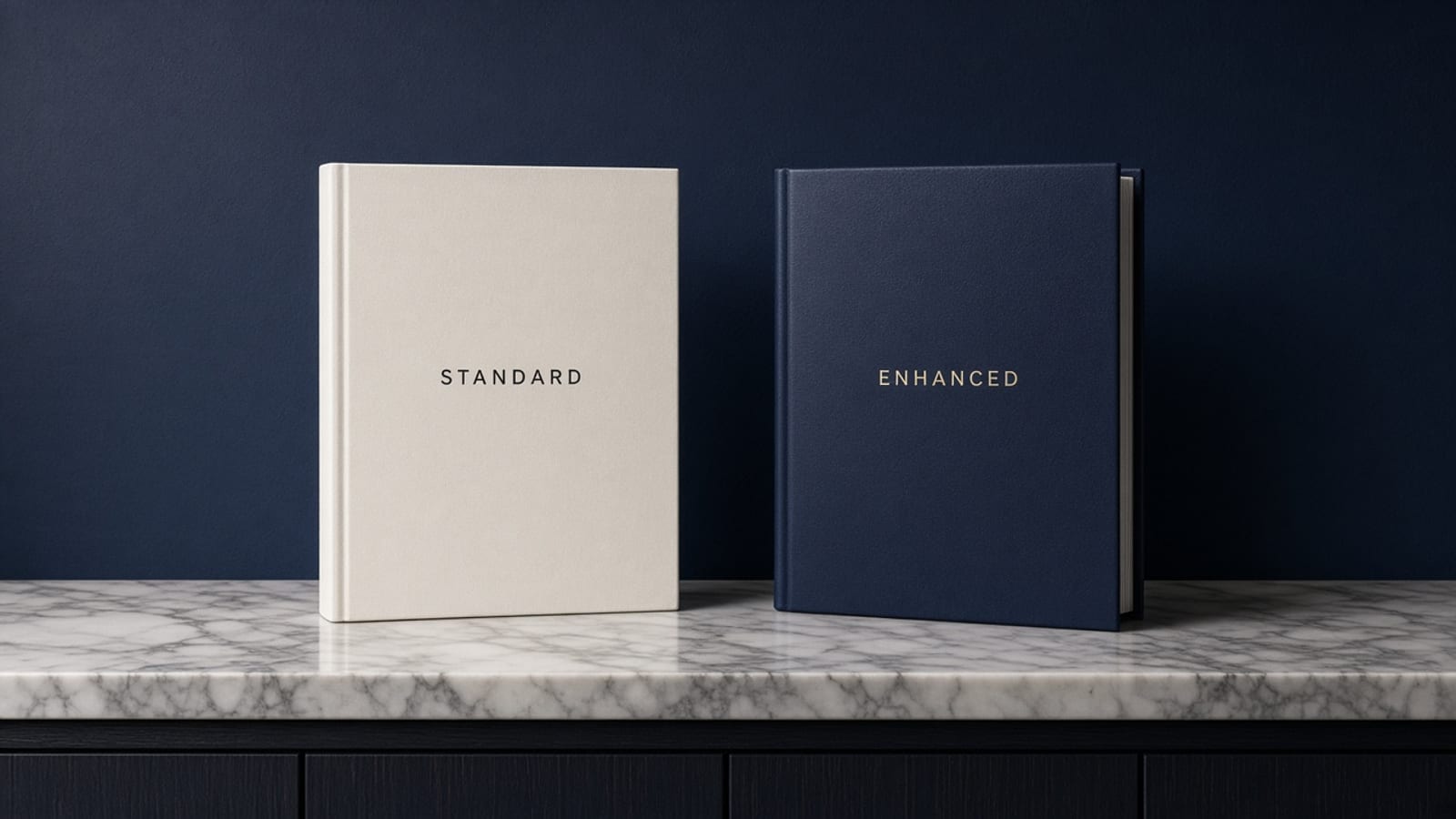 Two policy jackets labeled Standard and Enhanced standing on a marble credenza